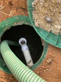 a green pipe with a green hose attached to it